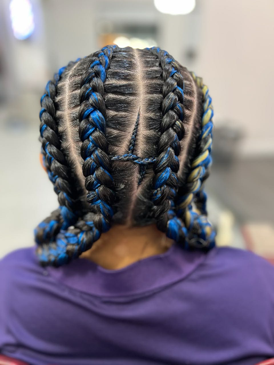 Butterfly braids with blue and gold accents, back view