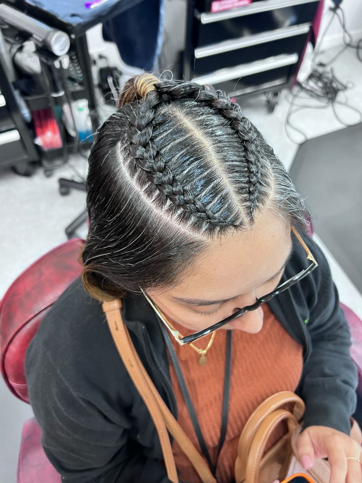 Feed-in cornrows swept up into an updo, overhead view