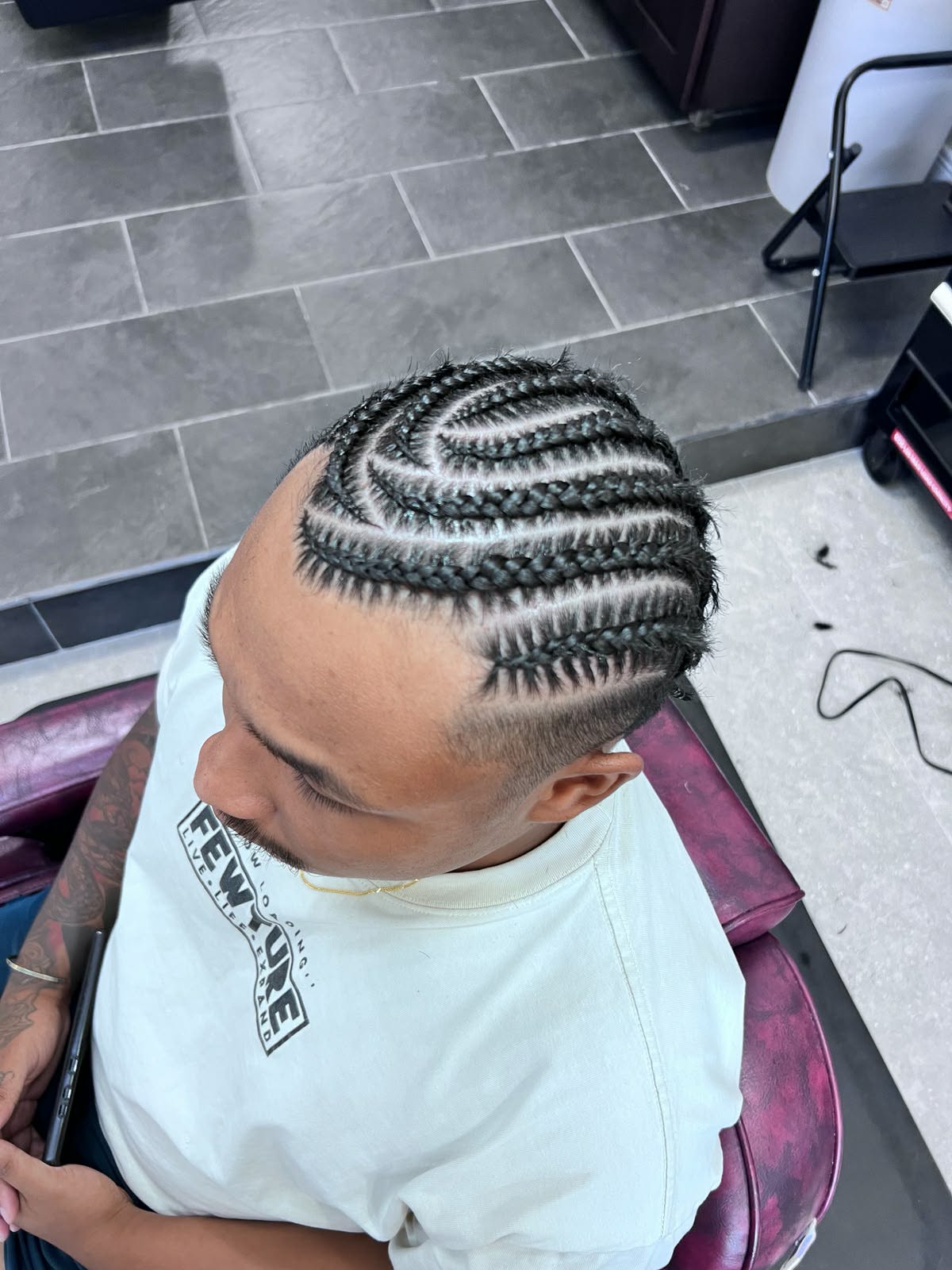Spiral stitch cornrows finished with an undercut fade