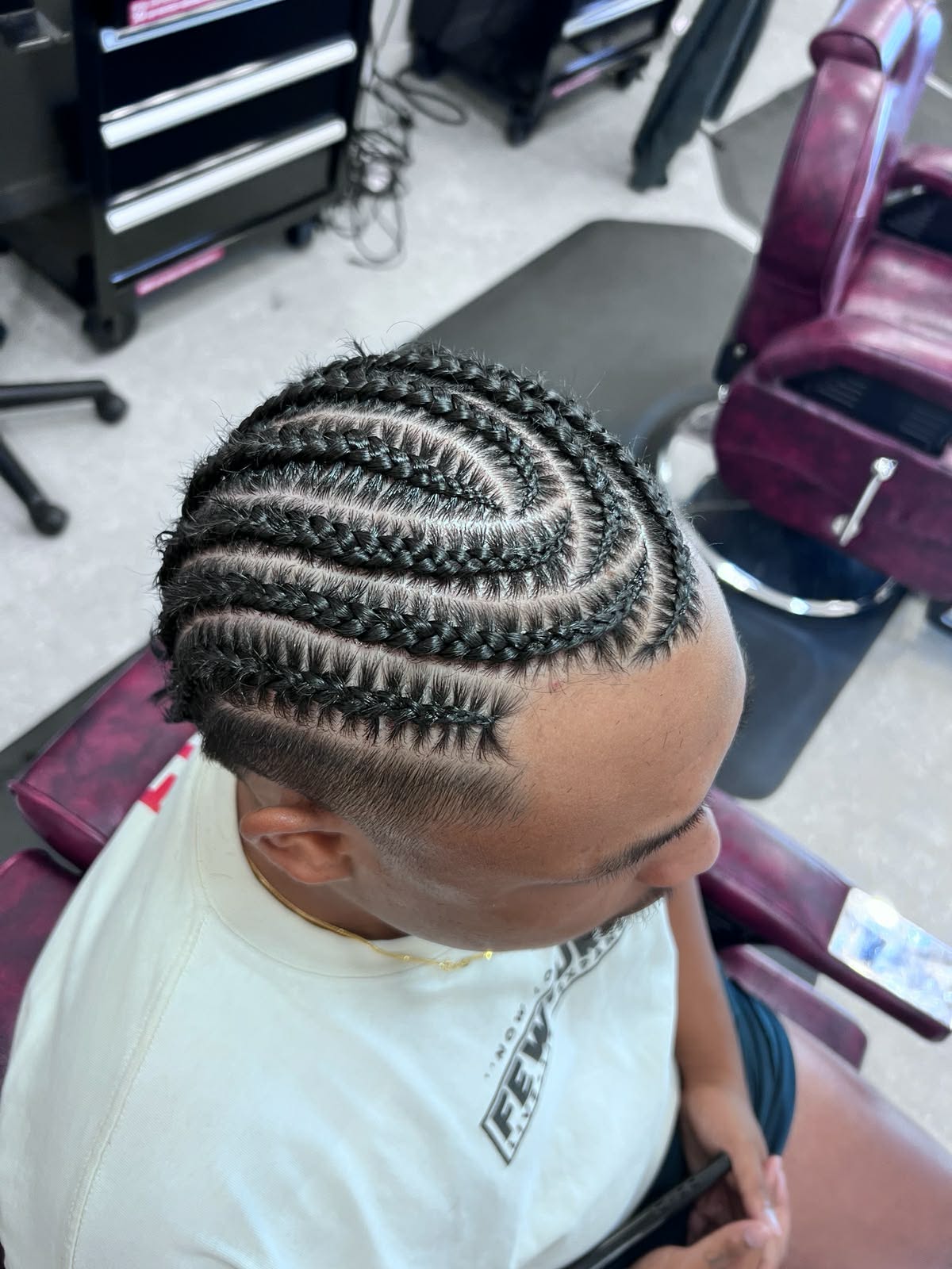 Swirl-pattern cornrows with a fade
