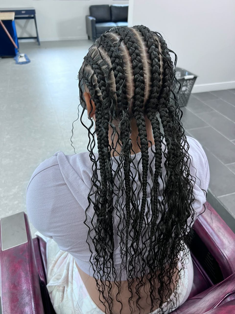 Boho knotless braids with loose curly strands, back view