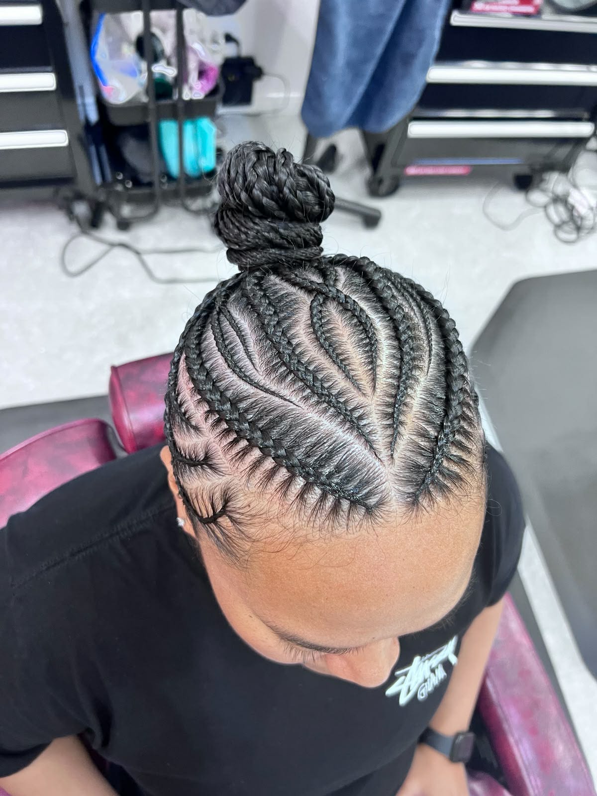 Feed-in cornrows gathered into a side bun